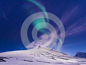 Polar arctic Northern lights aurora borealis sky star in Norway Svalbard in Longyearbyen city travel mountains