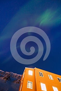 Polar arctic Northern lights aurora borealis sky star in Norway Svalbard in Longyearbyen the moon mountains