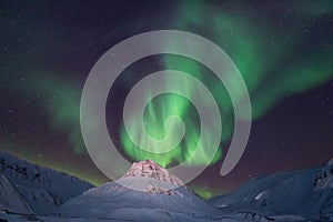 Polar arctic Northern lights aurora borealis sky star in Norway travel Svalbard in Longyearbyen city the moon mountains