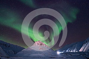 Polar arctic Northern lights aurora borealis sky star in Norway travel Svalbard in Longyearbyen city the moon mountains