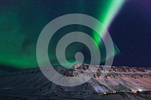 Polar arctic Northern lights aurora borealis sky star in Norway travel Svalbard in Longyearbyen city the moon mountains