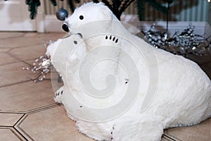 Polar bear with a teddy bear. The figure under the tree