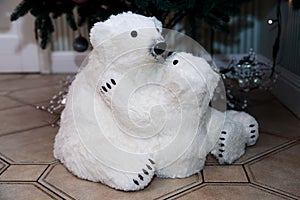 Polar bear with a teddy bear. The figure under the tree