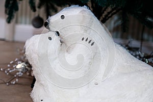 Polar bear with a teddy bear. The figure under the tree