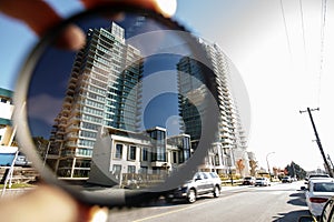 Polarizing filter held in front of a camera lens