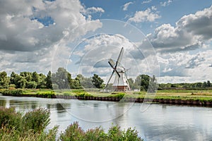 Polder landscape with canal and Witte Molen in Haren Glimmen in the Dutch province of Groningen