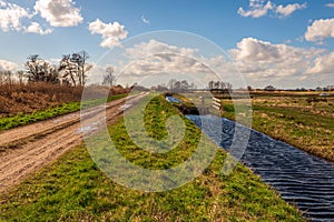 Polder landscape with sand path and ditch