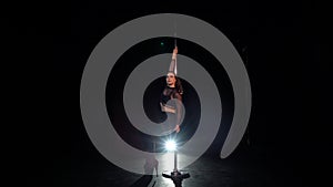 Pole dance. Young beautiful caucasian brunette woman dancer in studio.