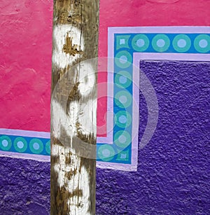 Pole in front of a painted wall