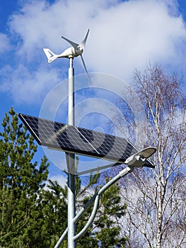 A pole with a innovative LED street light powered by solar cells panel and small wind turbine