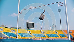 Pole vault - a bearded athletic man runs up holding a pole and jumping - failed attempt