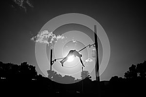 Pole vault silhouette. Professional athlete jumping at the stadium. Qualification Race for Worlds in Budapest and Games in Paris