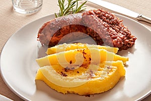 Polenta e salsiccia or cornmeal and pork sausage photo