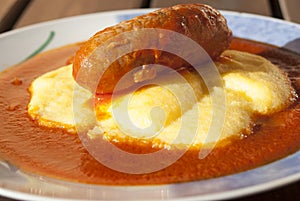 Polenta with tomato sauce and sausage photo
