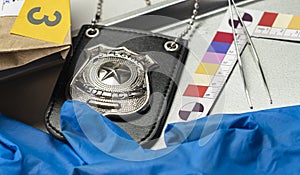 Police badge with gloves and ballistic measuring ruler