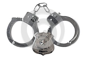 Police Badge and Handcuffs - Stock Photo