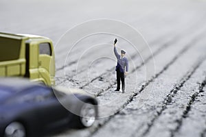 The police in the blue shirt standing and show his hand in front of the car in the road use as traffic and rescue concept