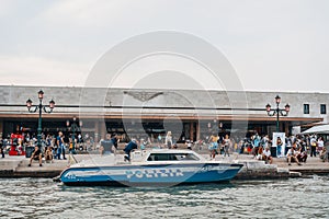 Police boat on Grand Canal outside Santa Lucia train station in Venice, Italy, view from water