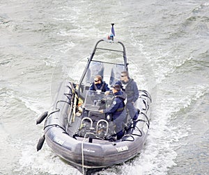 police boat on the Seine river with three officers