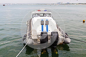 Police boat with two engines stands at the marina