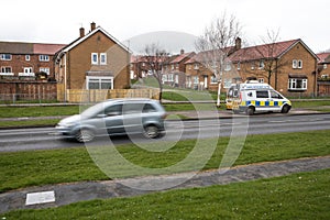 Police Camera Enforcement Unit Van parked at side of the road to enforce speed restrictions.  Speed camera sign visable as blurred