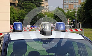 police car with blue lights sirens in the city