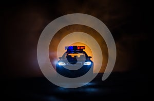 Police car chasing a car at night with fog background. 911 Emergency response police car speeding to scene of crime