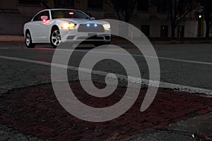 Police Car On City Street At Night