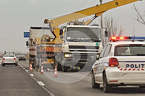 Police car and crane at crash site