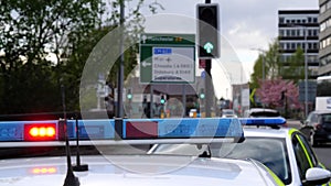 Police car emergency light flashing traffic driving past