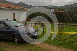 Police car and female police officer at the scene of kidnapping of children