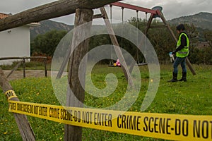 Police car and female police officer at the scene of kidnapping of children