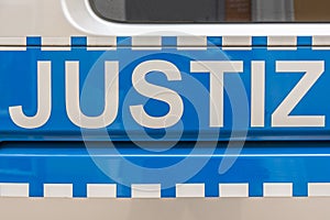 A police car labeled with the word justice