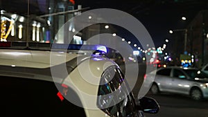 police car lights flickering in night city with selective focus and bokeh