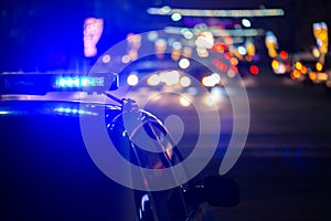 Police car lights at night in city with selective focus and bokeh