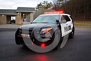 Police car with lights and siren on street