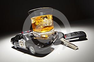 Police Car Next to Alcoholic Drink and Keys