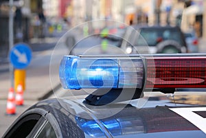 police car with red and blue sirens in the checkpoint