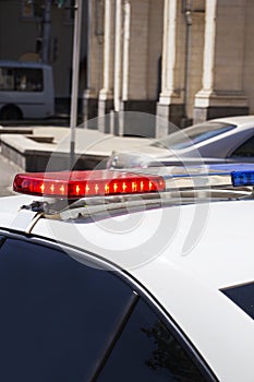 a police car with red and blue sirens at the checkpoint. Police work.