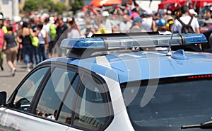 Police car with sirens in the crowd