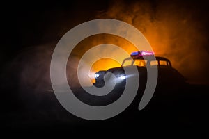 Police cars at night. Police car chasing a car at night with fog background. 911 Emergency response