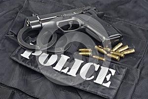 Police concept handgun on black uniform background