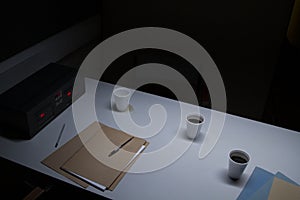 Police Custody Interview Room with Coffee Cups