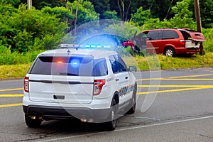 Police flashing blue lights at accident damaged car