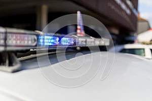 Police flashing light bar on top of the cop car