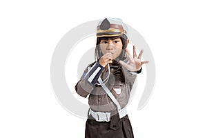 Police girl wearing a uniform with blow the whistle and hand stop gesture
