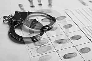 Police handcuffs and criminal fingerprints card photo