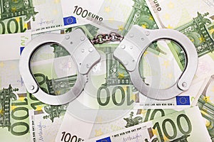 Police handcuffs on euro banknotes