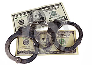 Police handcuffs false and real hundred-dollar bill.