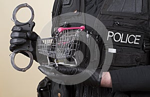 Police handcuffs and a supermarket trolley